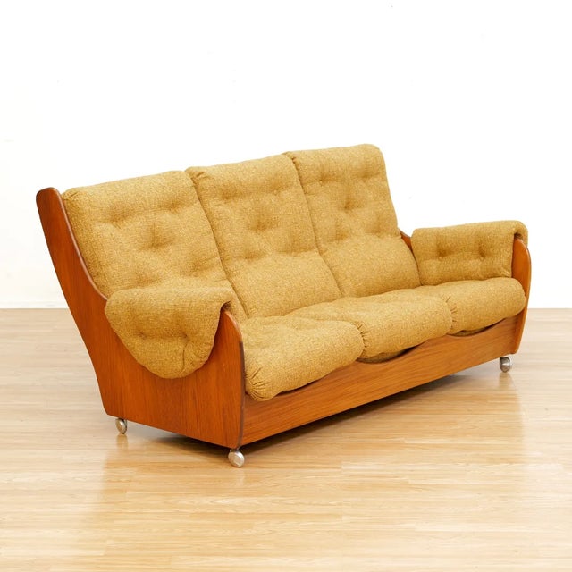 This 'Saddle Back' sofa, chair and ottoman set was manufactured by G Plan and designed by V.B. Wilkins during the 1970s....