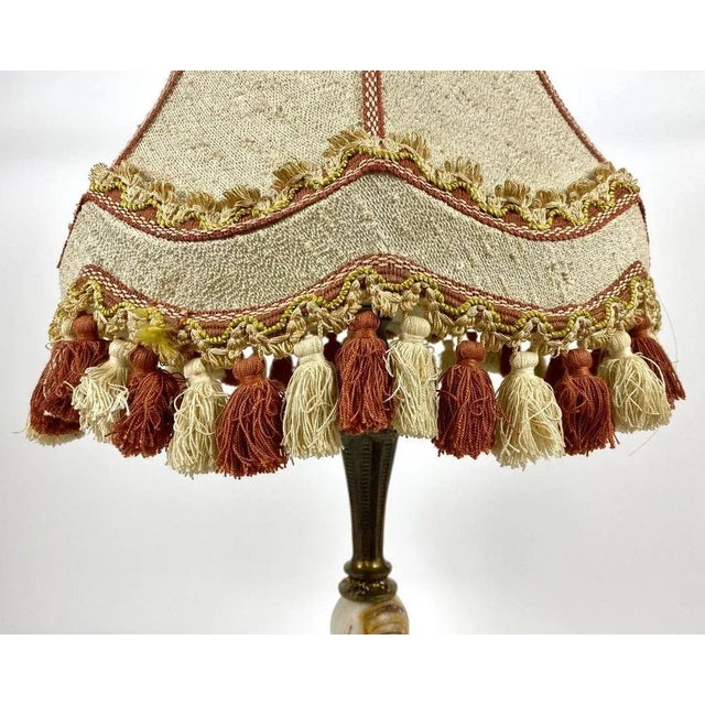 Beautiful and luxurious bronze and marble table lamp with beige shade and fringe, france, 1960s a vintage table lamp is...