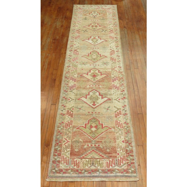 Turkish Anatolian runner with a simple multi medallion motif on a camel ground from the middle of the 20th century....