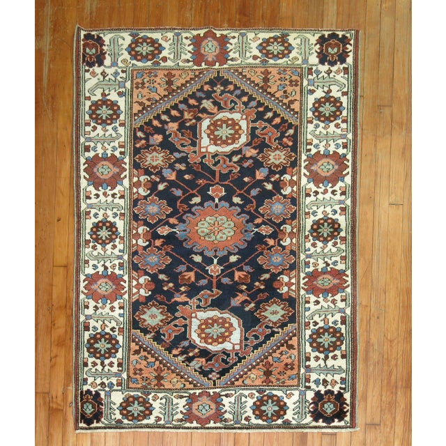 1930s Persian Bakhtiar rug with a large scale all over design on a navy field Measures: 3'9'' x 5'.