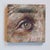 This artwork features a close-up view of an eye, rendered with rich oil paints that capture the intricate details and...