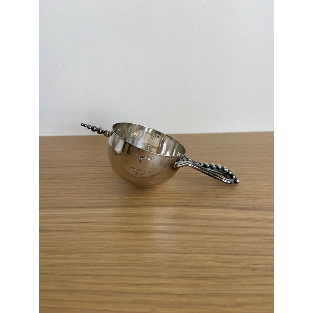 A classic Napier Company “Bottoms Up” jigger in silver plate — an iconic piece of American barware design. This sculptural...