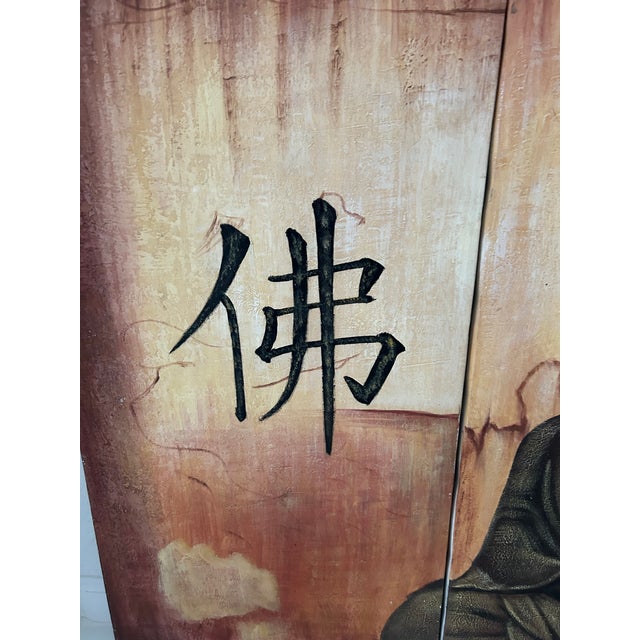 Large three-piece canvas painting of a sitting Buddha under what would be a Bodhi Tree. The symbol on the far-left canvas...