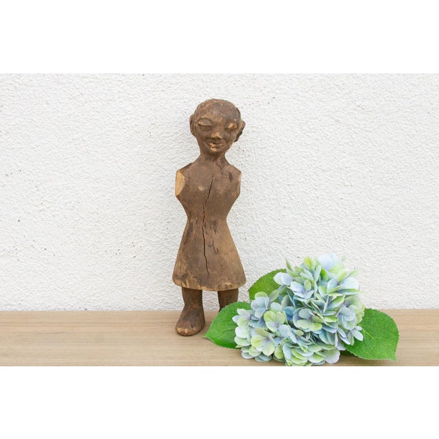 This is a beautifully aged, hand-carved wooden figure of African origin, showcasing the raw, authentic artistry typical of...