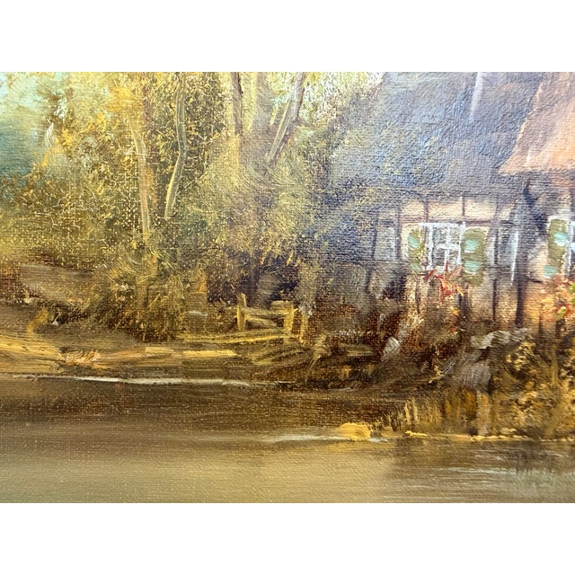 This signed oil on canvas by Josef Benda (German, born 1937) depicts a tranquil European village landscape featuring...