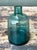 This vintage small teal glass vase embodies the refined simplicity and functional elegance associated with mid-20th-...