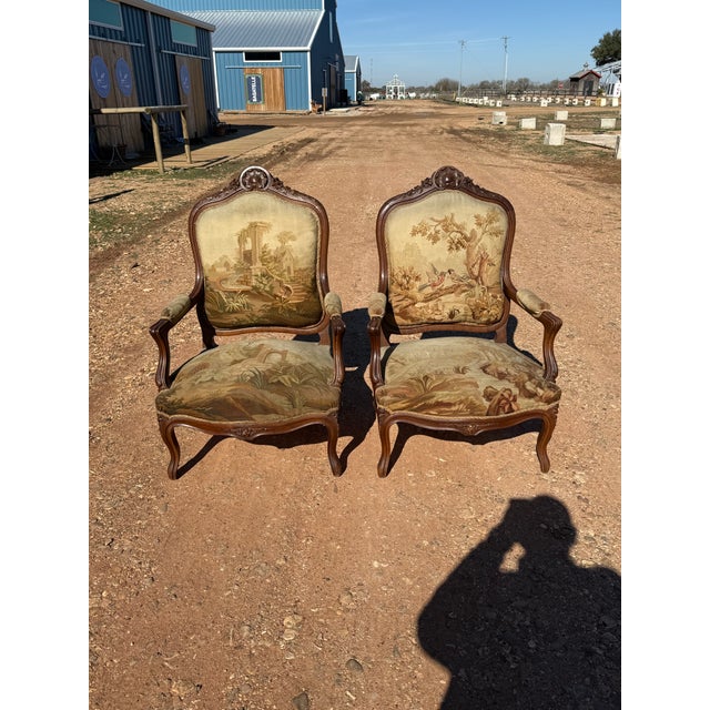 Large Pair of French Louis XV Armchairs from France made of solid walnut, the wood has been finished with a lustrous...