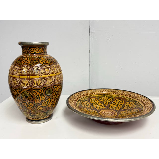 Design Plus Gallery presents a Moroccan Ceramic Vase + Bowl Set. The coordinating ceramic pieces display intricate...
