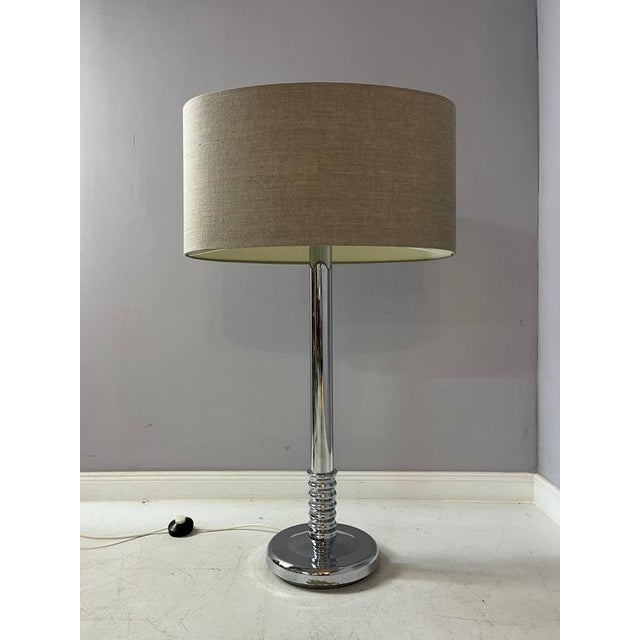 This chrome floor lamp with a gray shade combines elegant design with timeless aesthetics. The shiny chrome housing gives...