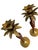 A charming pair of vintage Hollywood Regency palm tree candlesticks combining warm carved wood with sculptural brass...