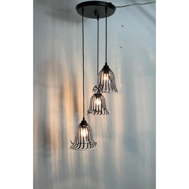 Three lights chandelier with Murano glass bowls from the 80s attributable to Toni Zuccheri x Venini. The transparent and...