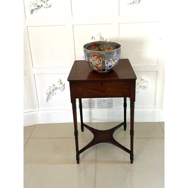 Antique Regency freestanding quality mahogany inlaid lamp table having a quality mahogany inlaid lift top with a reeded...