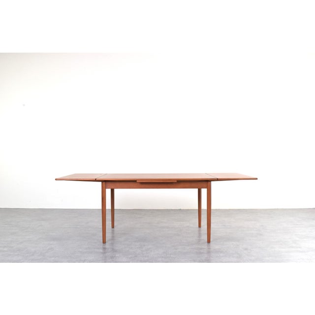 This teak table was manufactured in Denmark in the 1960s. It has been professionally and carefully restored by removing...