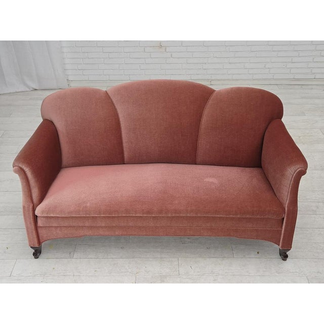 1950s, Danish 2-seater sofa. Salmon pink furniture velour, oak wood legs, brass springs in the seat. Sofa was...