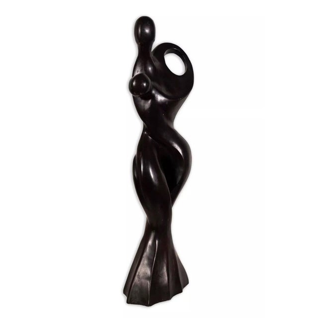 A postmodern solid wood carved sculpture depicting a dancing couple. The curved abstract stylization is reminiscent to the...