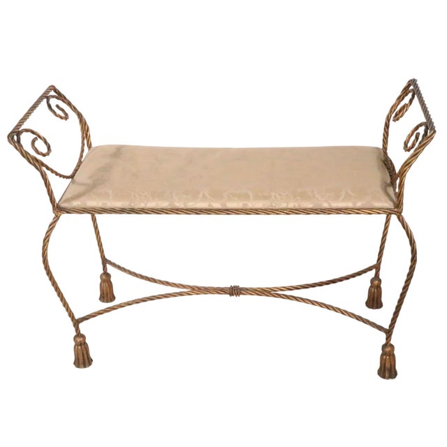 Stylish, chic and voguish gold finish, twisted rope form frame, with decorative metal tassel feet, and a rectangular pad...