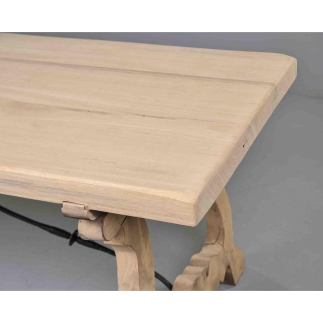 This striking Italian trestle table draws from a furniture tradition rooted in the Renaissance, its lyre-shaped trestle...