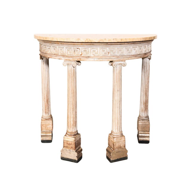 Neoclassical revival demi-lune. Marble top and Greek key apron. Four ionic columned legs.