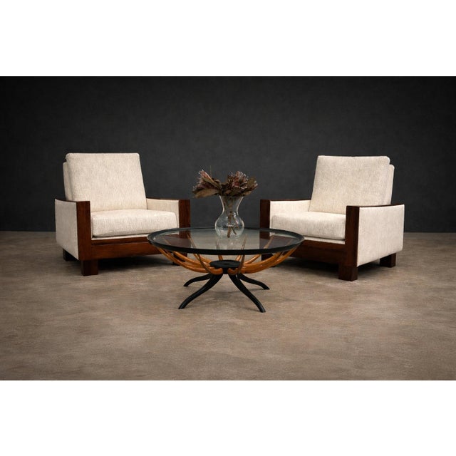 A strong and architectural pair of Brazilian modern armchairs produced by Celina, dating to the 1960s. Defined by clean...