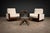 A strong and architectural pair of Brazilian modern armchairs produced by Celina, dating to the 1960s. Defined by clean...