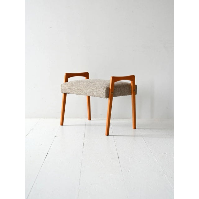 Vintage Scandinavian footstool crafted from solid oak in the 1960s, featuring simple, elegant lines and exposed metal...