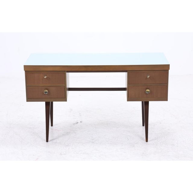 A beautiful desk from the 60s with a clean, understated design. Four drawers, neatly integrated and easily accessible. A...