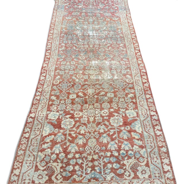 An elegant antique Persian-style runner, likely dating to the early 20th century, featuring an allover floral design...