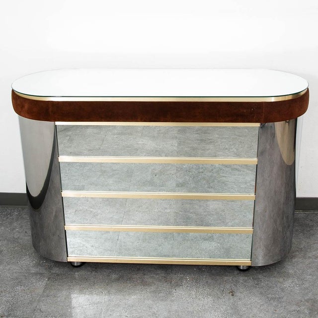 Fantastic 1970s bar cabinet with a curved mirror design and brown velvet detailing. Includes a mini fridge and additional...