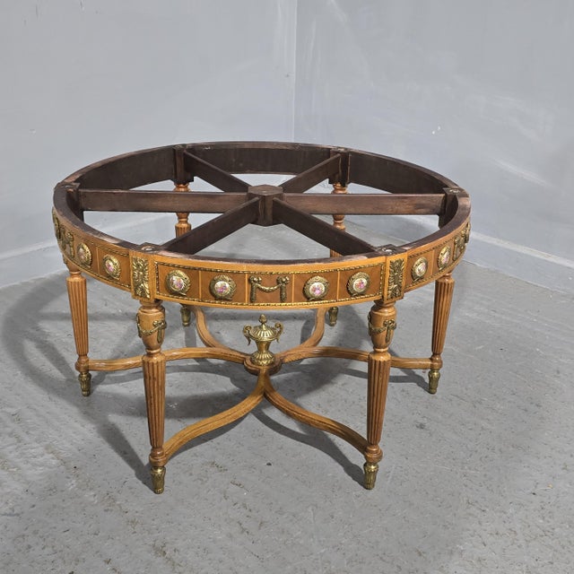A very pretty six leg walnut coffee table with ormolu feet mounts and urn, 32 ormolu mounted porcelain plaques, and green...