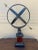 A Grand Tour–style classical armillary sphere being held up by the mythological figure Atlas, mounted on a square burl...