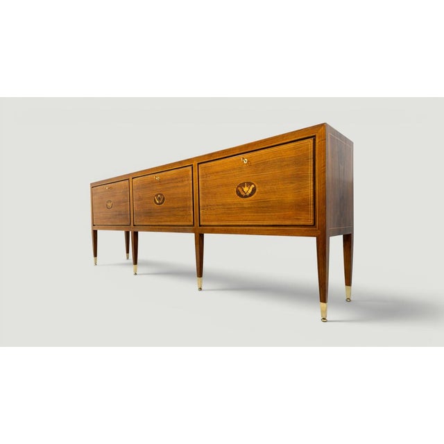 This elegant Italian sideboard designed by Paolo Buffa, represents a refined synthesis of neoclassical inspiration and...