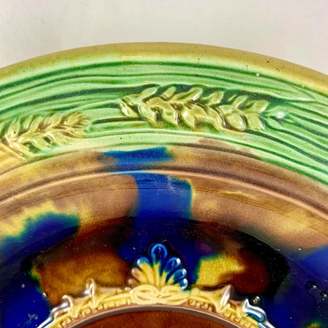 A scarce majolica English bread tray, or wall plaque, circa 1850-1880, maker unknown. The central medallion image is...