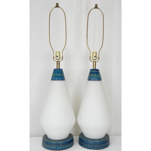 Rare pair of Mid-Century Modern lamps featuring a combination frosted white glass with Rimini Blu Bitossi ceramic neck and...
