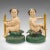 This is a pair of antique decorative figures. An English, painted cast iron putto on elm base, dating to the Victorian...