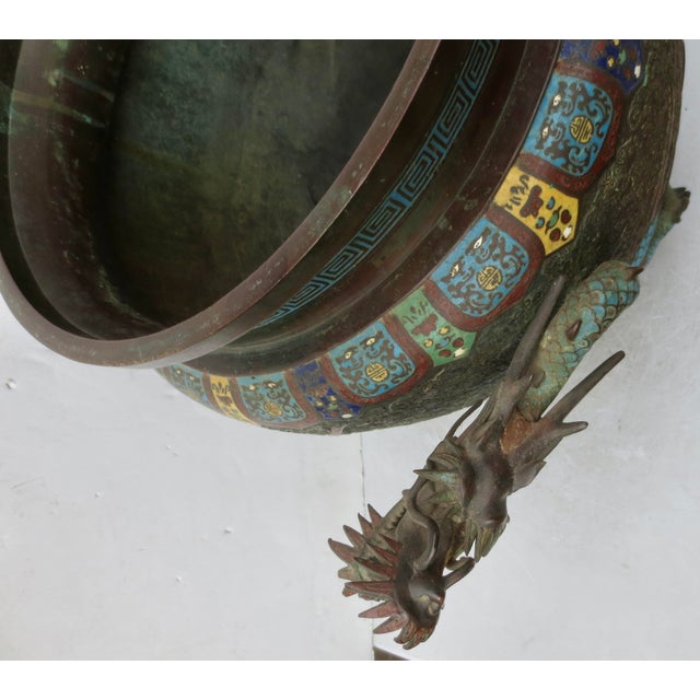 Dragon wrapped Bronze urn, or incense burner. Champleve enamel to highlight the dragon and lighting across a field of...