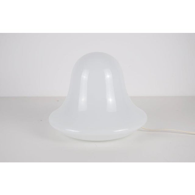 Italian mushroom table lamp from the 1970s, made with a single softly shaped opaline glass body. The rounded shade flows...