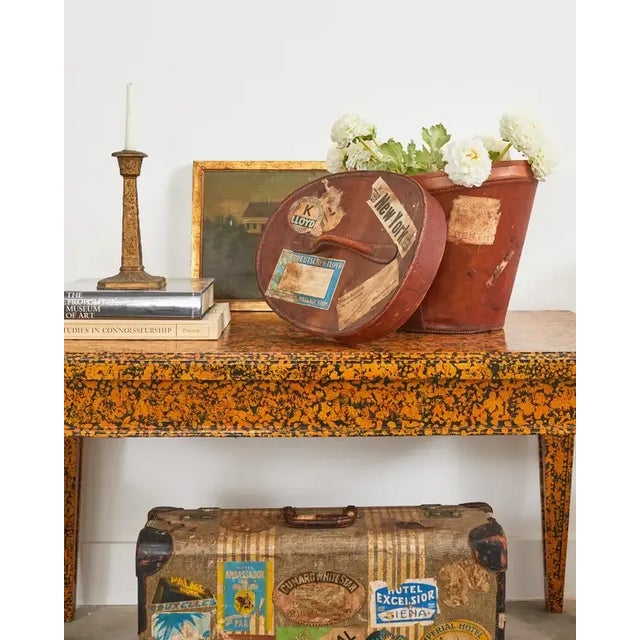 Rustic early 19th century English regency oval hat box with a carry handle. The box is crafted from leather and features...