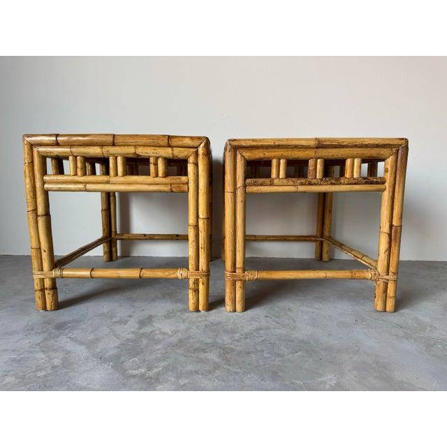 Pair of vintage bamboo and rattan side tables in a charming coastal boho chic style. Each table features a sturdy bamboo...