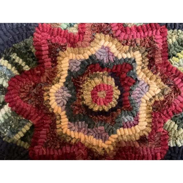 This wool geometric textile wall hanging measures 56” wide x 36” tall. It is hand hooked with over dyed wool strips cut...