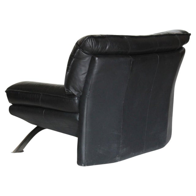 Finely crafted black cowhide leather seat. Steel supporting structure. This piece is attributed to the mentioned...