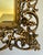 Here is a vintage Hollywood Regency vanity mirror with an wonderfully ornate gilt metal filigree frame and an especially...