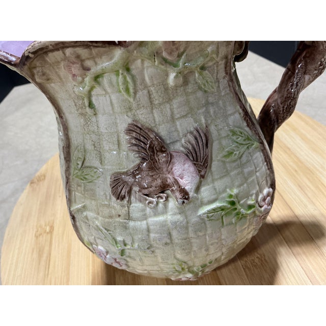 An authentic late 19th-century Victorian majolica water pitcher crafted circa 1880–1890. This piece features high-relief...