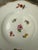 This antique German Meissen porcelain small bread & butter or dessert plate features hand-painted scattered flowers and...