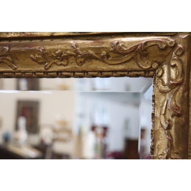Elegant antique Italian mirror dating back to the early 20th century. An extremely refined mirror. Made with a finely...