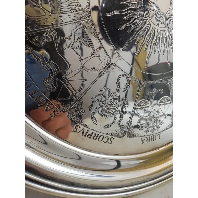 Beautiful collector's plate by Fleuron Christofle. It represents the signs of the zodiac with the sun inside them with...