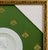 White background with a circular shape, decorated in the center with the profile of Emperor Napoleon I, his head turned to...