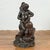A Greco-Roman inspired vintage bronze fountain depicting a putto riding a dolphin. This Greco-Roman inspired vintage...