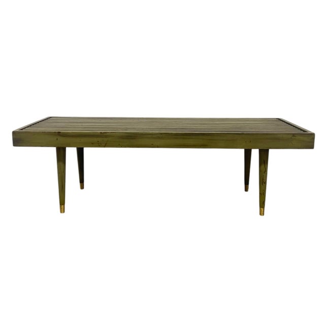 Vintage mid century modern bench featuring a linear slatted top set within a rectangular frame. The evenly spaced slats...