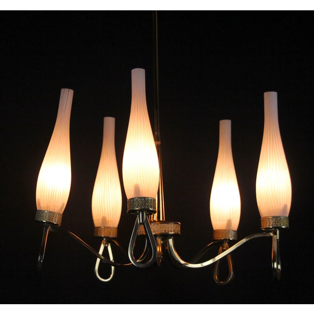 Very beautiful Brass chandelier, with elegant white opalines, five lights. Attributed to the Maison Arlus, produced during...