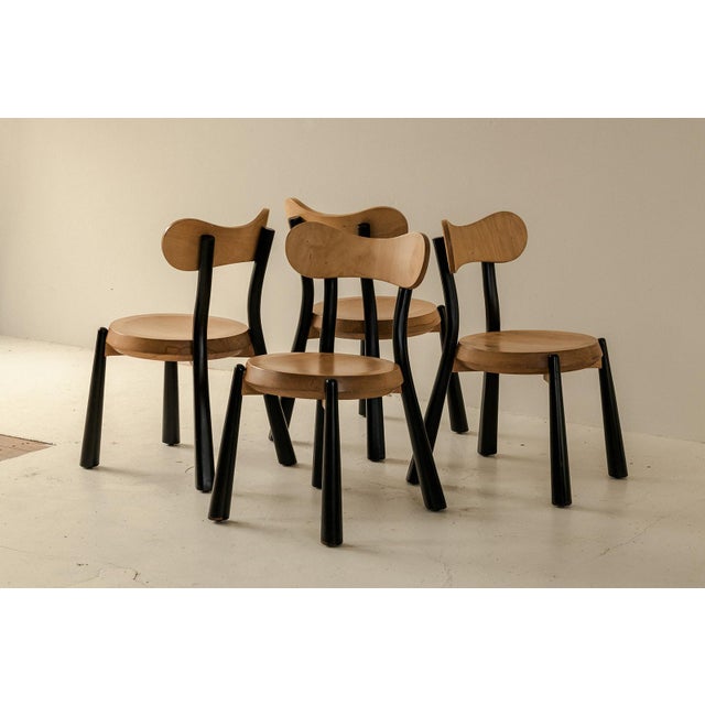 Set of 4 dining chairs produced in France around 1980. These playful chairs have a solid beech frame with black lacquered...